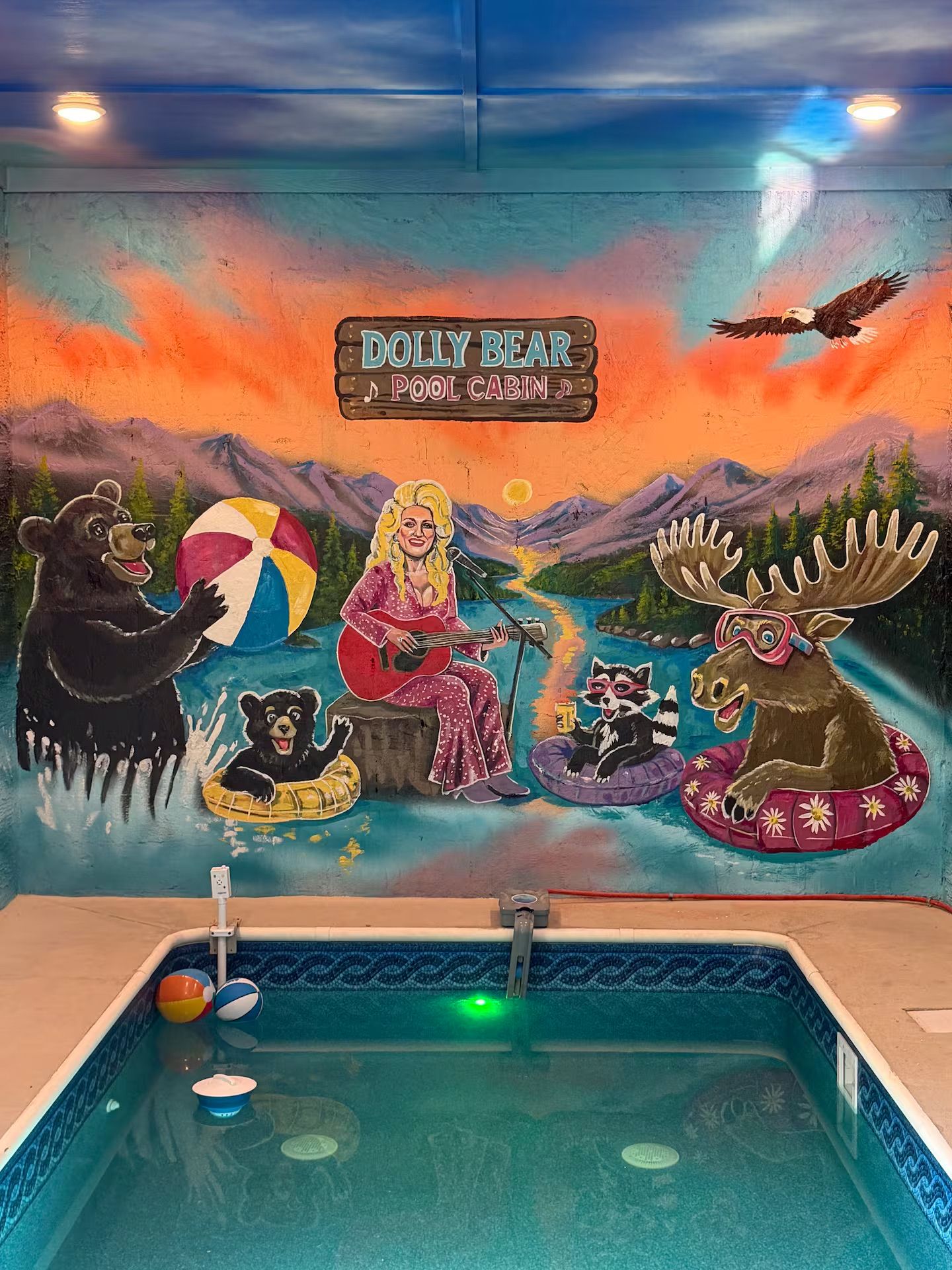 Private indoor pool with playful mountain mural and fun cabin charm