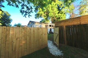 A wooden fence with a gravel path leading to a house. - Private & Pet-Friendly Guesthouse Near Marietta Square w/ Fenced Yard + King Bed (Marietta)
