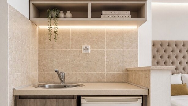 A compact kitchenette with a built-in dishwasher, a sink, and a small countertop. - Guest House Fjola (Donji Štoj)
