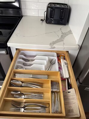 A kitchen with a white marble countertop, a toaster, and a drawer organizer with utensils. - Awesome 3-bedroom house with AC in delightful Chattanooga (Chattanooga)