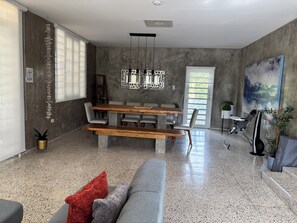 A modern living space with a dining area, a sofa, a bench, and a large abstract painting. - Private, Luxury Villa with Heated Pool    MI CASA ES TU CASA (San Lorenzo)