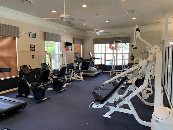 A gym with various exercise equipment, including treadmills, stationary bikes, and weight machines. - Water view condo in Fort Myers, with screened lanai (Fort Myers)