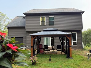 A two-story house with a covered patio area. - 2 Home Combo - 9 Bedrooms Total / Rent 2 Homes / Large Group / Multi Family (Denver)