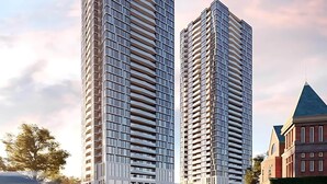 Zwei moderne Hochhäuser mit symmetrischer Gestaltung, ausgestattet mit mehreren Balkonen und einer Glasfassade.
