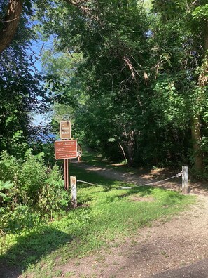 A signpost with information about Birch Beach, including a map and rules for visitors.