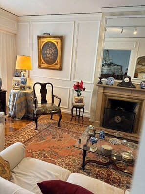 A traditional living room with a fireplace, ornate furniture, and a chandelier. - Spacious Recoleta apartment in desired location - French style & Modern Comfort (Buenos Aires)