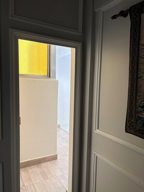 A doorway leading to a room with a view of a balcony and a patterned wall. - Spacious Recoleta apartment in desired location - French style & Modern Comfort (Buenos Aires)
