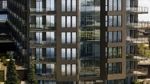 A multi-story building with a modern architectural design, featuring balconies and large windows. - Modern Waterfront Condo with Harbour Views (Victoria Central British Columbia Provincial Government)