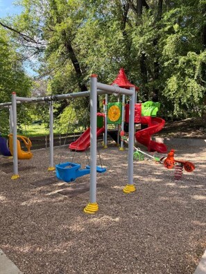 A playground with a climbing structure, slides, and swings. - Stylish Apartment near City Center (Chișinău)