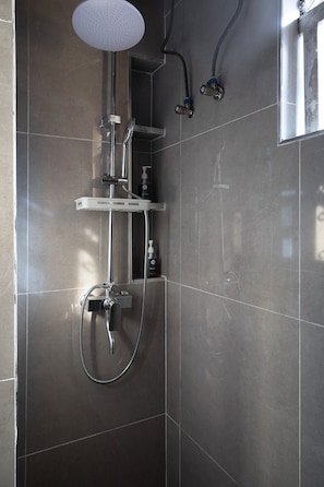 A modern shower with a handheld showerhead, a wall-mounted faucet, and a handheld shower hose. - The Mercy Studio - near Wuse 2, Maitama (Abuja)