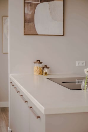 A kitchen with a white countertop, a sink, and two jars with lids. - 2BR Rooftop Terrace in Rotterdam City Centre (Rotterdam)