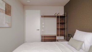 A bedroom with a bed, a wardrobe, and a bedside table. - 2BR Rooftop Terrace in Rotterdam City Centre (Rotterdam)