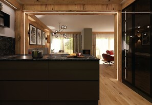 Une cuisine moderne avec un plafond en bois, un îlot central doté d’un évier et un coin repas avec une chaise rouge.