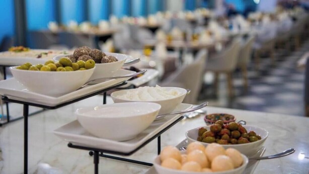 A buffet setup with various food items including olives, meatballs, and eggs. - Business Bay Hotel Apartment (Dubai)