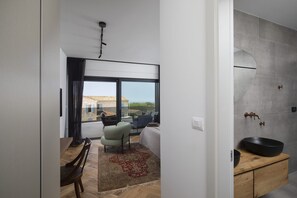 A modern interior with a dining area, a sofa, and a view of the outside. - Villa BB near Rovinj (Bale)
