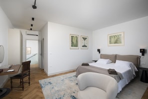 A bedroom with a bed, bedside tables, a desk, a chair, and artwork on the walls. - Villa BB near Rovinj (Bale)