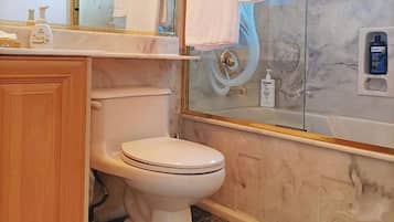 Combined shower/tub, free toiletries, hair dryer, slippers