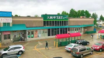 Una tienda T&T con toldo verde y un letrero en un idioma extranjero.