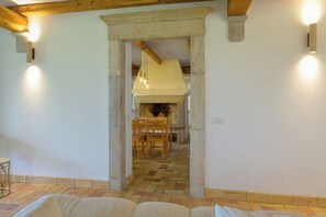 A room with a stone fireplace, wooden furniture, and a tiled floor. - Villa delle Cese (Campagnano di Roma)