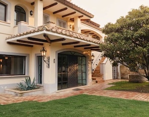 A two-story house with a covered patio, a large glass door, and a brick pathway. - Villa delle Cese (Campagnano di Roma)