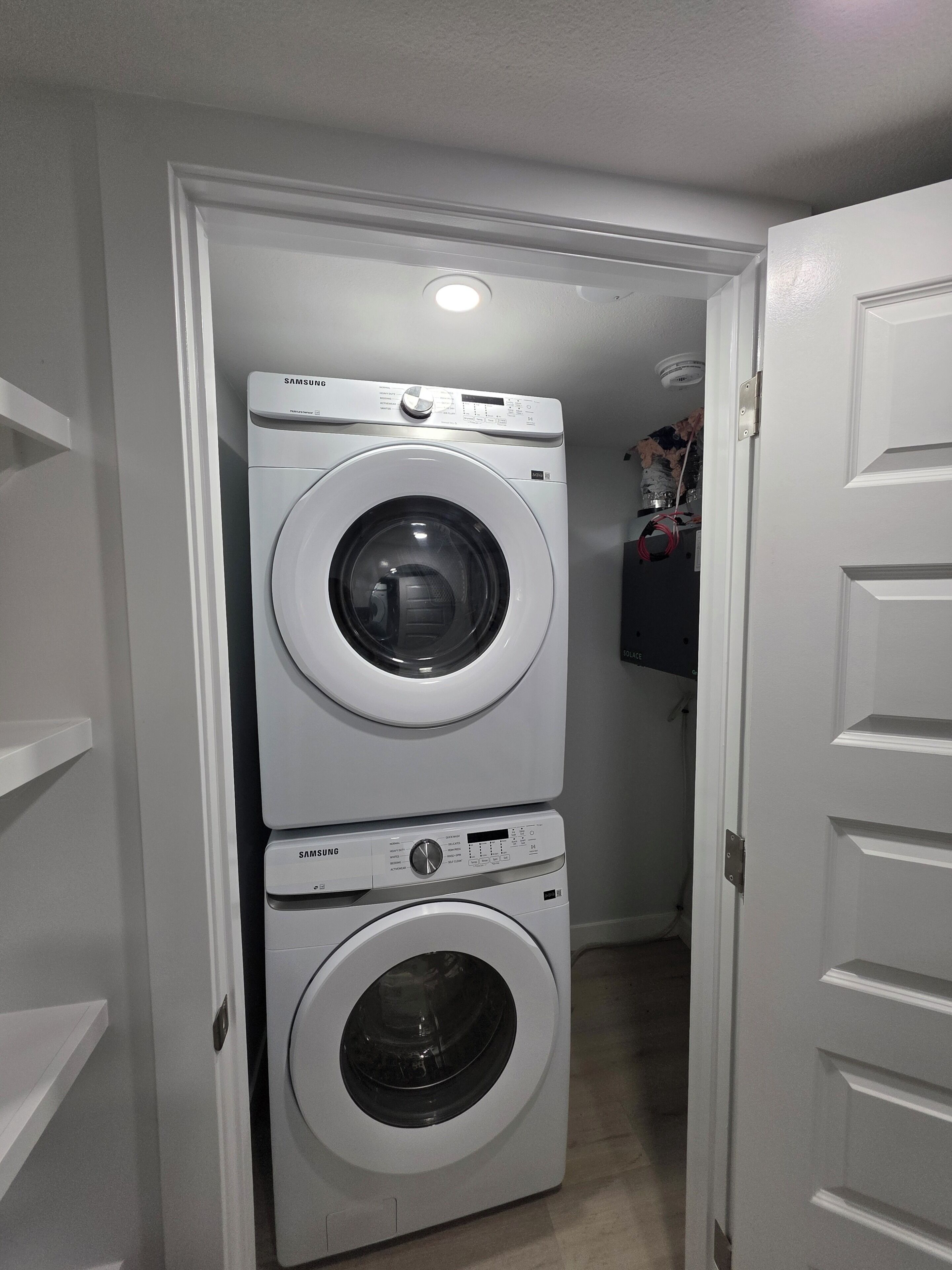 A laundry room with two stacked front-loading washing machines.