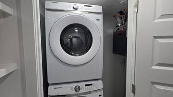 A laundry room with two stacked front-loading washing machines.