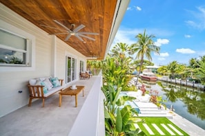 A wooden ceiling, a wooden bench, a wooden table, a pool, and a boat. - Private Beach, Waterfront, Islamorada, Island house with a pool & a boat dock (Islamorada)
