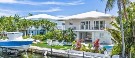 Une propriété située au bord de l’eau, dotée d’une piscine, d’un quai pour bateaux et d’un aménagement paysager luxuriant de style tropical.