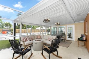 An outdoor covered patio with a sofa, chairs, and a table. - Coastal Cactus- Pool+Pickleball+Putting Green+Shuffleboard! (Manatee County)