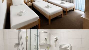 Habitación de hotel con dos camas, baño con ducha, lavamanos e inodoro.