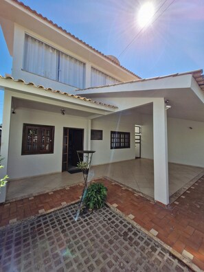 A two-story house with a covered patio area.