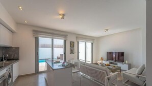 A modern apartment with a kitchen, dining area, and a living room with a TV. - Luxury Villa with private pool Sholan 2 (Red Sea Governorate)