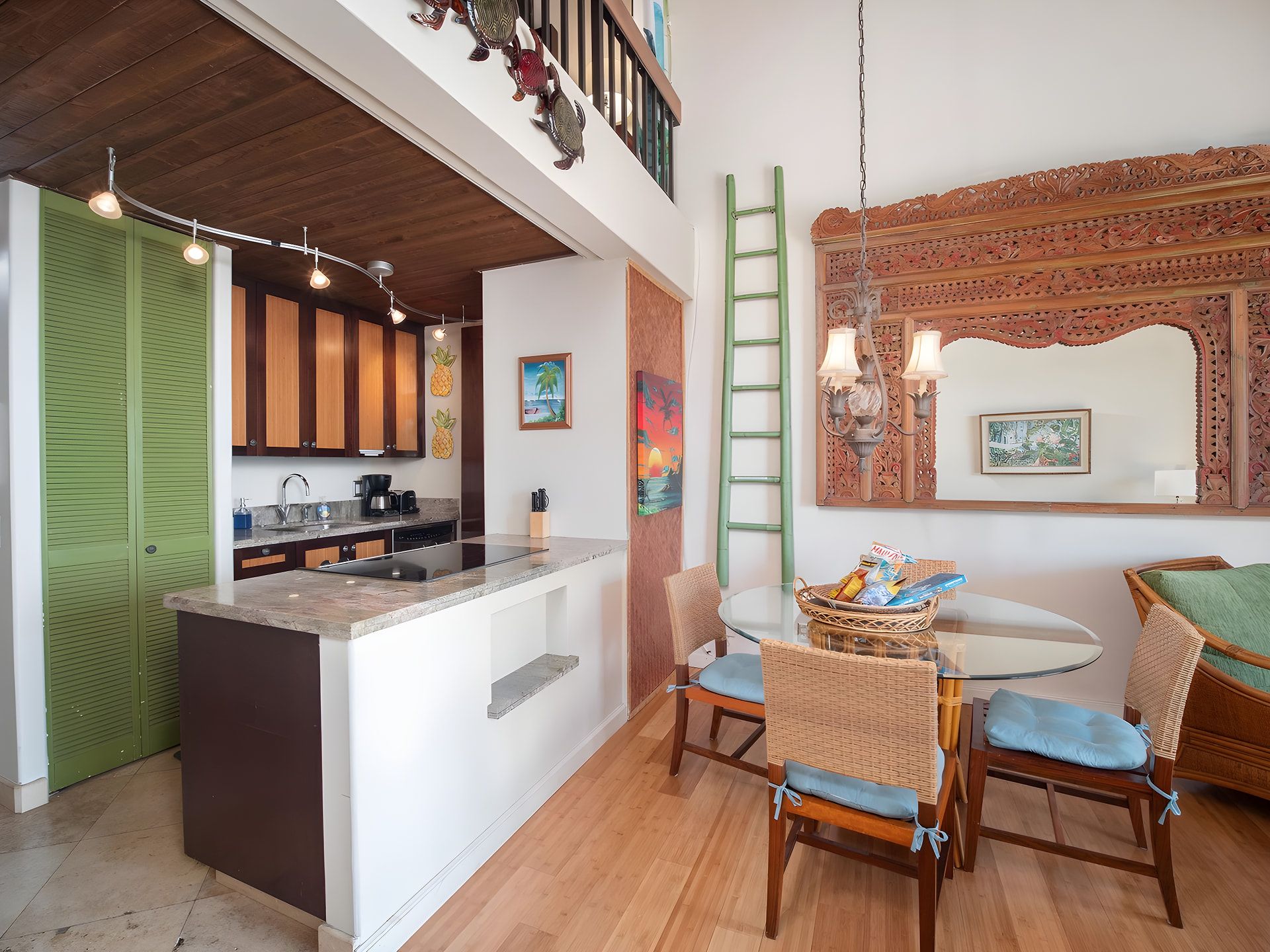 A modern kitchen with a central island, wooden cabinets, and a dining area with wicker chairs and a glass table.