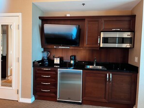A compact kitchen with a built-in microwave, a toaster, and a refrigerator. - MGM Signature Deluxe Suite • Strip, Sphere & F1 Track Views • No Resort Fee (Las Vegas)
