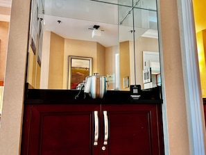 A kitchen area with a refrigerator, a microwave, and a coffee machine. - MGM Signature Deluxe Suite • Strip, Sphere & F1 Track Views • No Resort Fee (Las Vegas)
