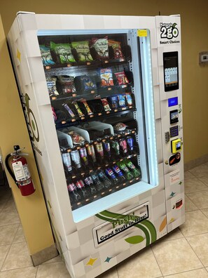 A vending machine with a variety of snacks, drinks, and other items. - Oceanfront Studio, Beach & City Views, Jacuzzi, Heated Pool, Direct Beach Access (Daytona Beach)