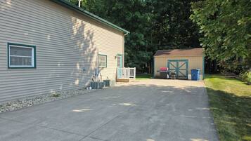 A residential property with a garage, a covered outdoor area, and a paved driveway.