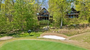A golf course with bunkers and a flagstick. - McLemore Resort - 835 Rushing Water Trail - Golf Course View, Forested Cabin (Rising Fawn)