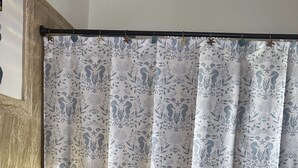 A bathroom with a toilet, a shower curtain with a floral pattern, and a bathtub. - Peaceful Studio Retreat Near Shoal Bay Beach - AC, Wi-Fi, Concierge Support (Shoal Bay Corner)