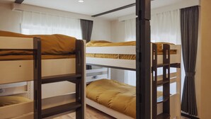 A bunk bed room with a wooden floor and white walls. - kadoya (Kosuge)