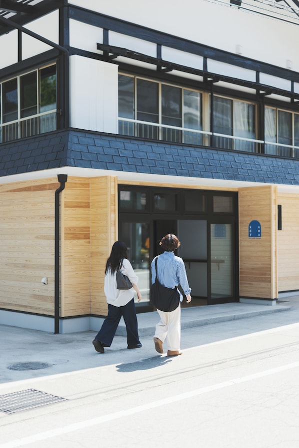 A modern building with a wooden facade and large windows.