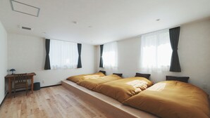 A room with two beds, a desk, and a chair. - kadoya (Kosuge)