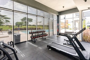 A gym with a treadmill, dumbbells, and a bench. - Vista Cana private Jacuzzi + Golf + Beach + Pool (Punta Cana)