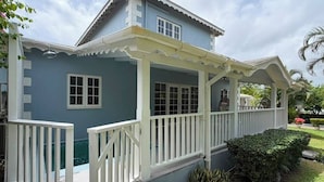 A two-story house with a covered porch, a swimming pool, and a well-maintained garden. - Cap Estate 3BR Townhome, Private Plunge Pool, Golf (Gros Islet)
