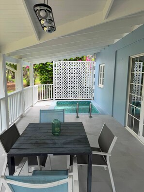 A covered outdoor area with a pool, a table with chairs, and a white fence. - Cap Estate 3BR Townhome, Private Plunge Pool, Golf (Gros Islet)
