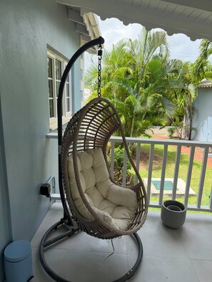 A hanging chair on a porch with a view of palm trees and a garden. - Cap Estate 3BR Townhome, Private Plunge Pool, Golf (Gros Islet)