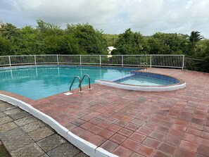 A rectangular swimming pool with a tiled deck, surrounded by a white fence, and a smaller hot tub area. - Cap Estate 3BR Townhome, Private Plunge Pool, Golf (Gros Islet)