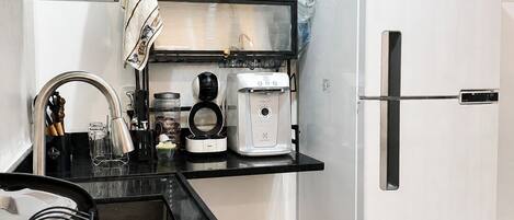 Coffee/tea maker, microwave, stovetop, dining tables