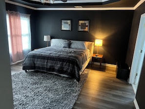 A bedroom with a bed, nightstands, a rug, and a ceiling fan. - Gorgeous Executive Master Suite + Private Bedroom 2-bedroom in friendly Mableton (Mableton)