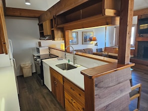 A kitchen with wooden cabinets, a stainless steel sink, and a microwave. - 2BR/2B Condo with Hot Tub/Pool access. 4.5 Miles to Jackson Hole Mountain Resort (Wilson)